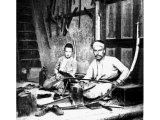 With primitive tools these swordmakers turn out blades of first-class quality. An early photograph.